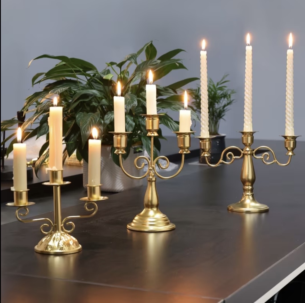 Polished gold cone pillar candle holders with white pillar candles