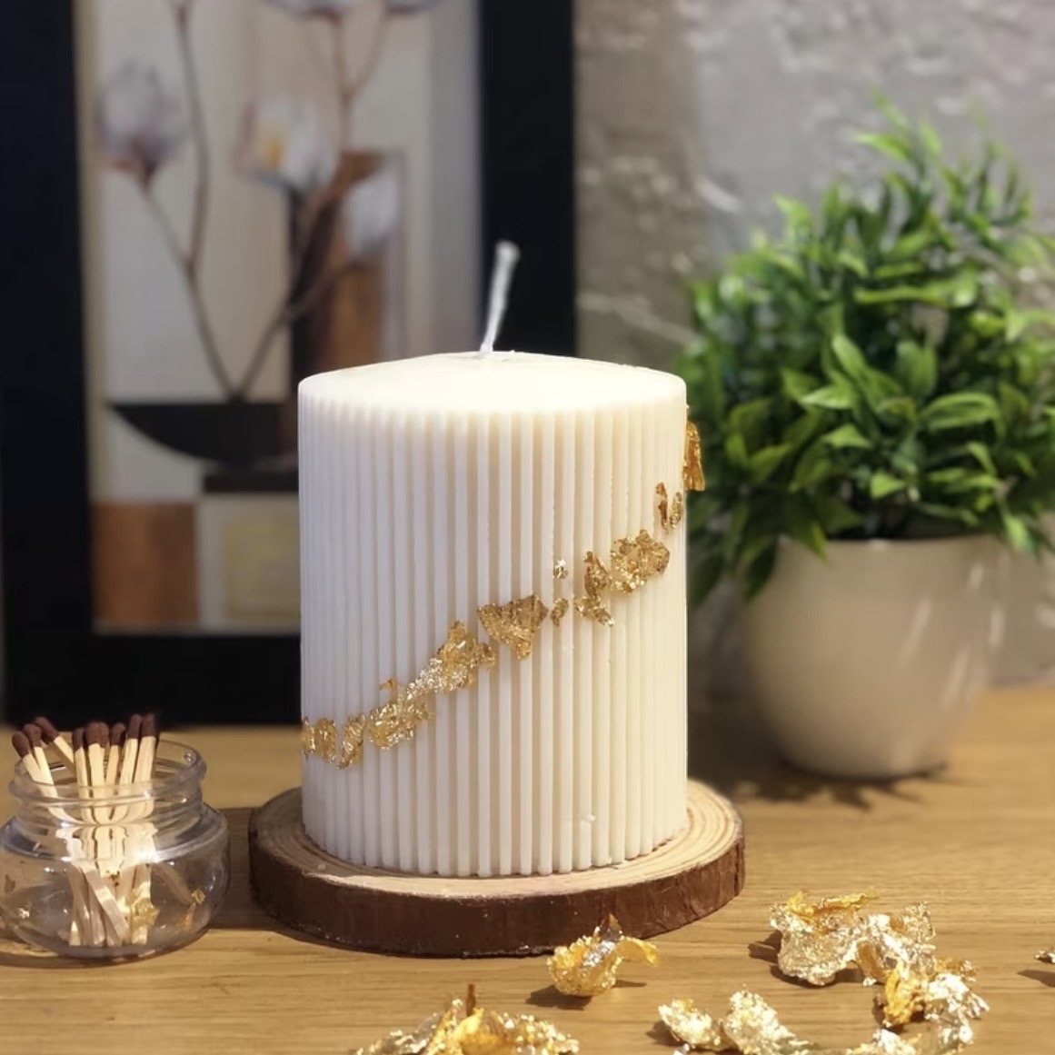 Gilded Ribbed Pillar Candle — A refined ivory pillar traced with gold leaf.