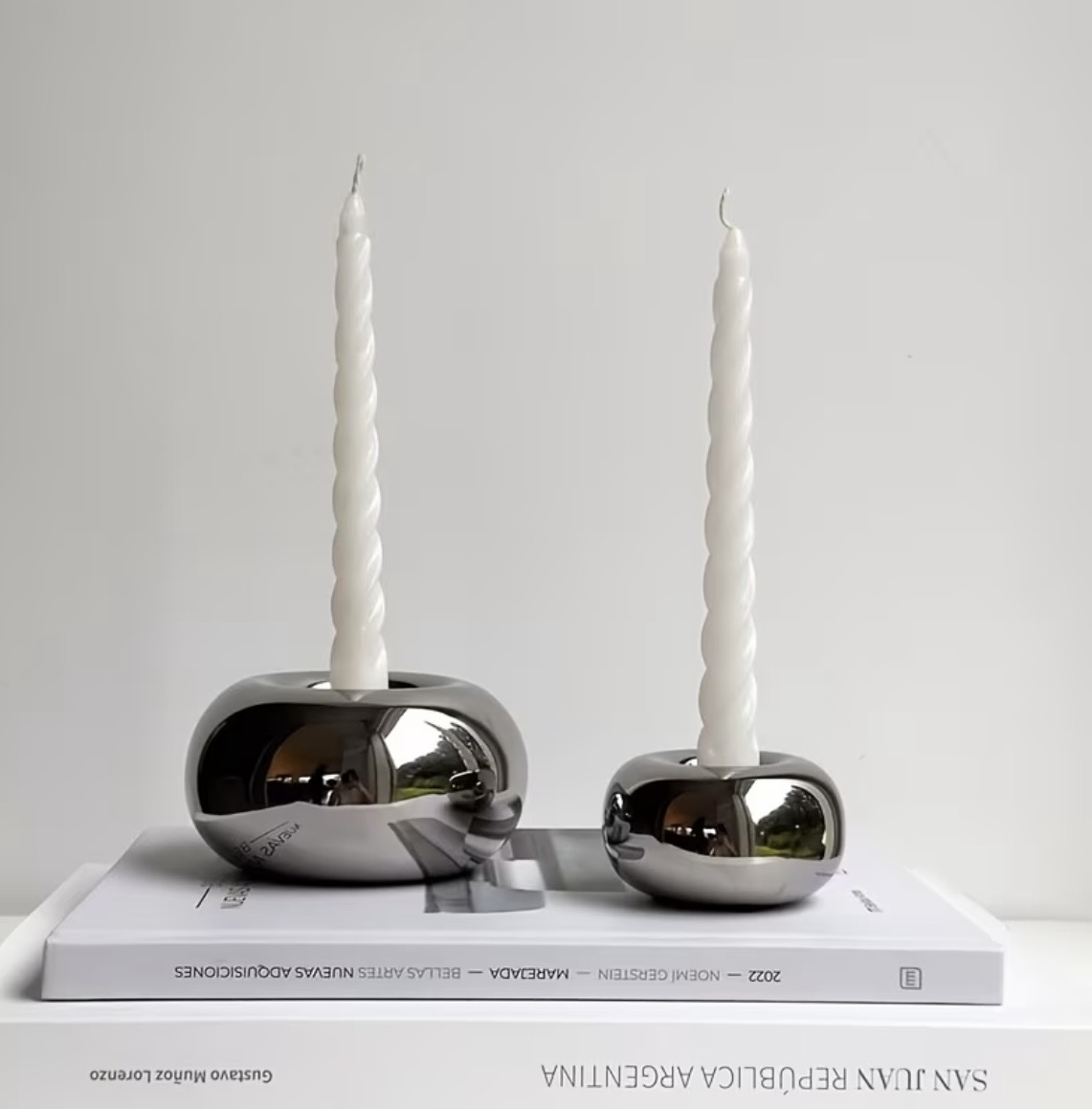 Polished silver pebble candle holders with twisted taper candles
