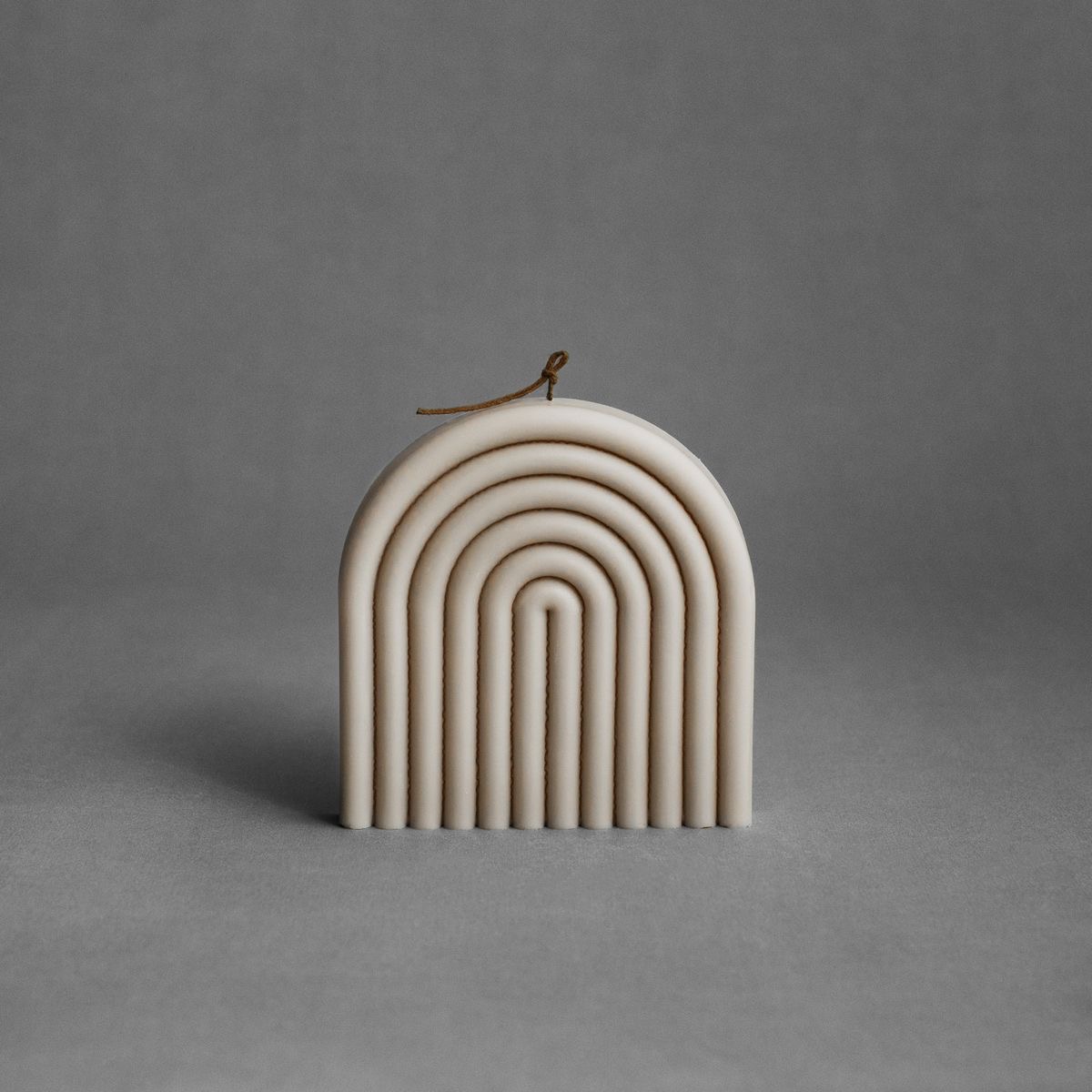 Small Arch Candle — A compact arch with layered curves.
