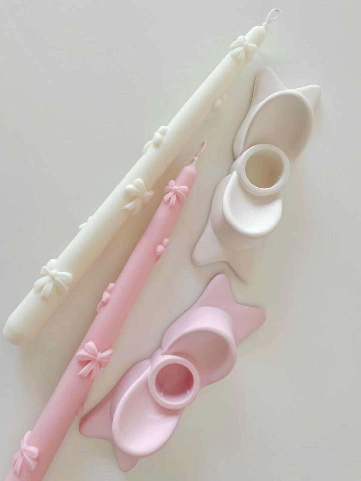 Bow Taper Candle Pair — Slender tapers finished with delicate wax bows.