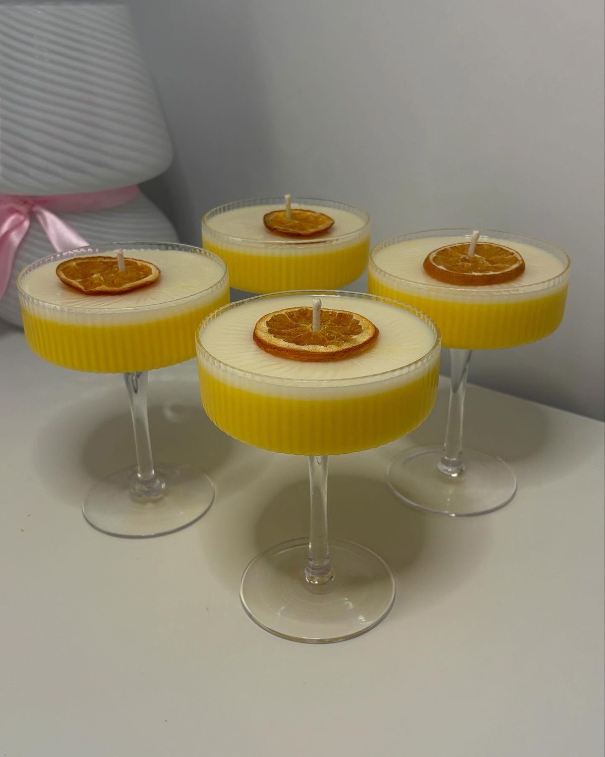Citrus Spritz Coupe Candle — Sunshine-yellow layers crowned with a dried orange slice.