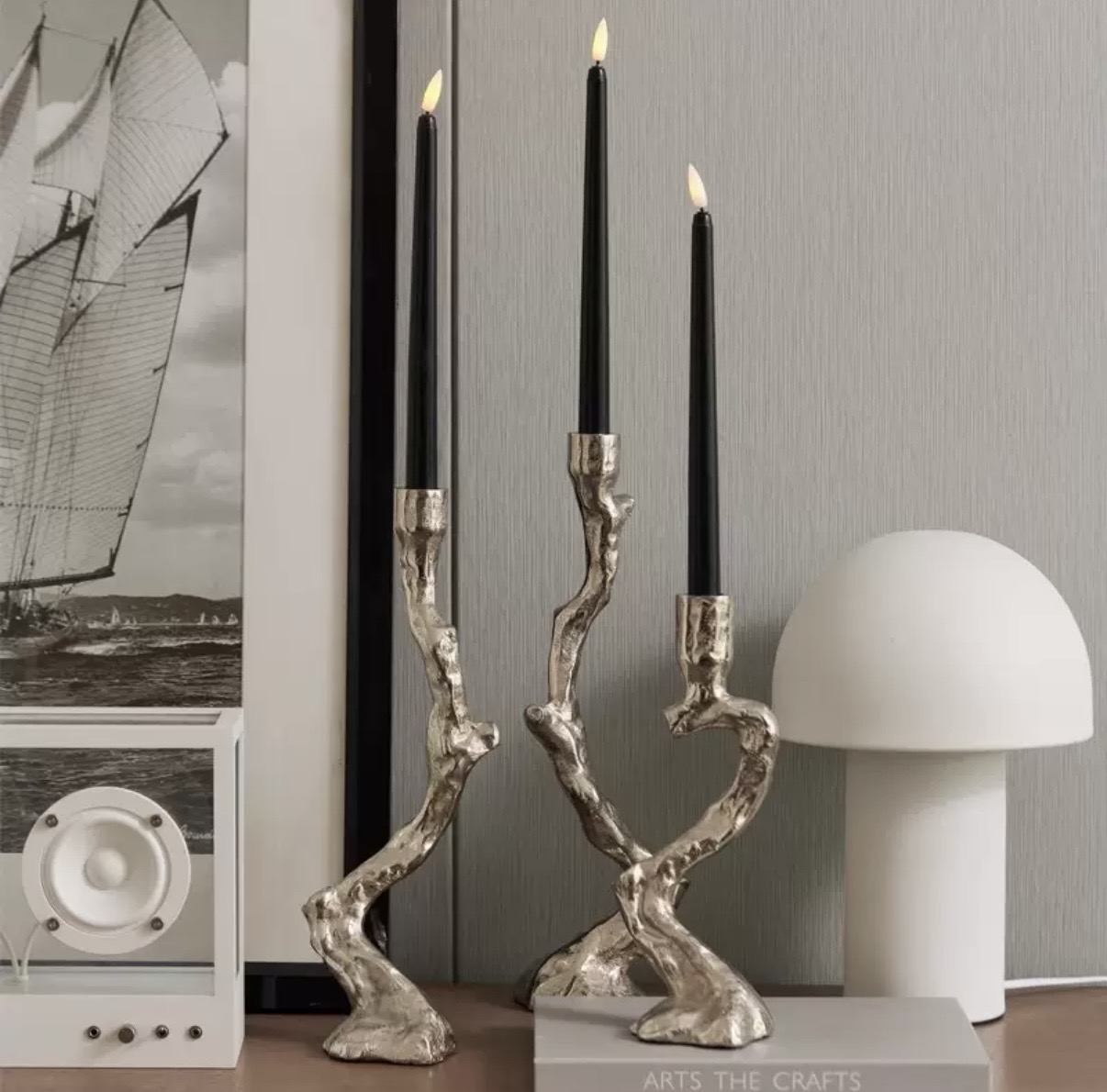 Sculptural silver branch-form candelabras with black taper candles