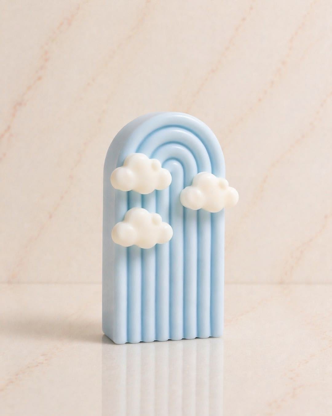 Cloud Arch Candle — A softly ribbed sky arch with floating clouds.