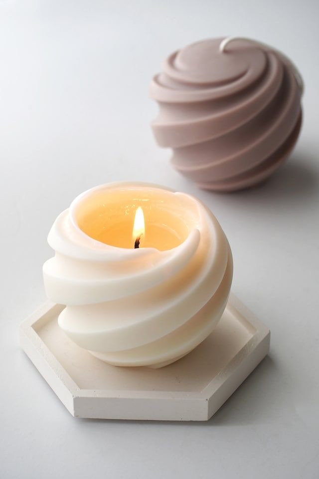 Sculptural Swirl Candle — A rounded candle shaped by generous flowing folds.