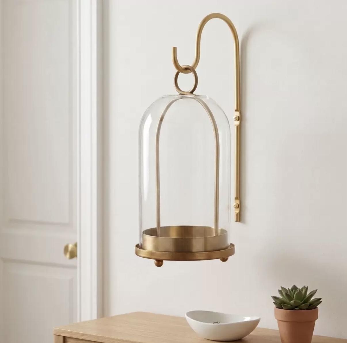 Brass wall-mounted glass cloche candle holder
