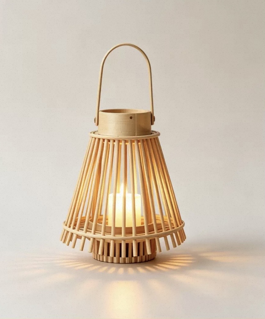 Slatted bamboo cone lantern with a lit pillar candle