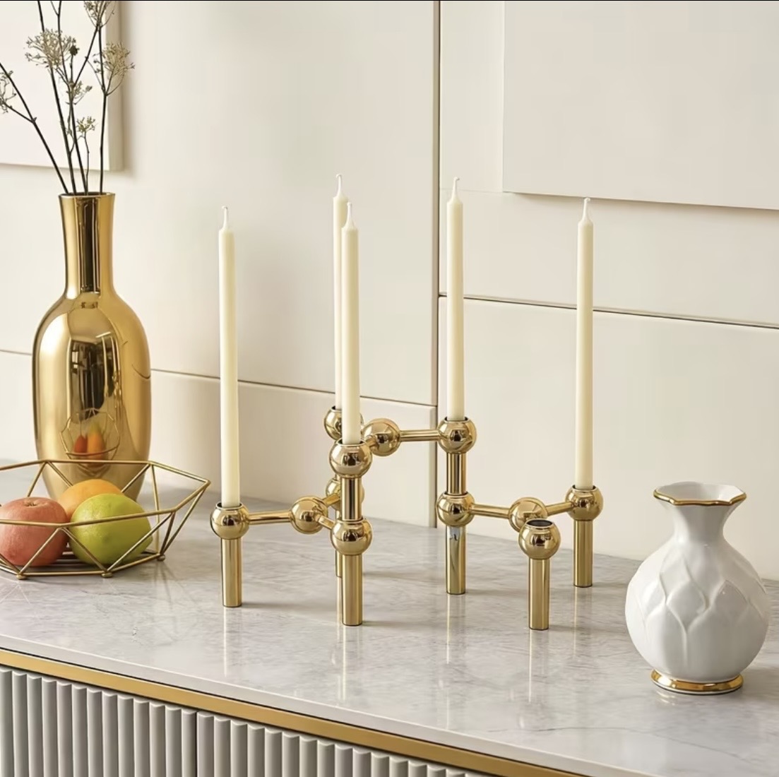 Modern gold ball-joint candelabra holding five taper candles