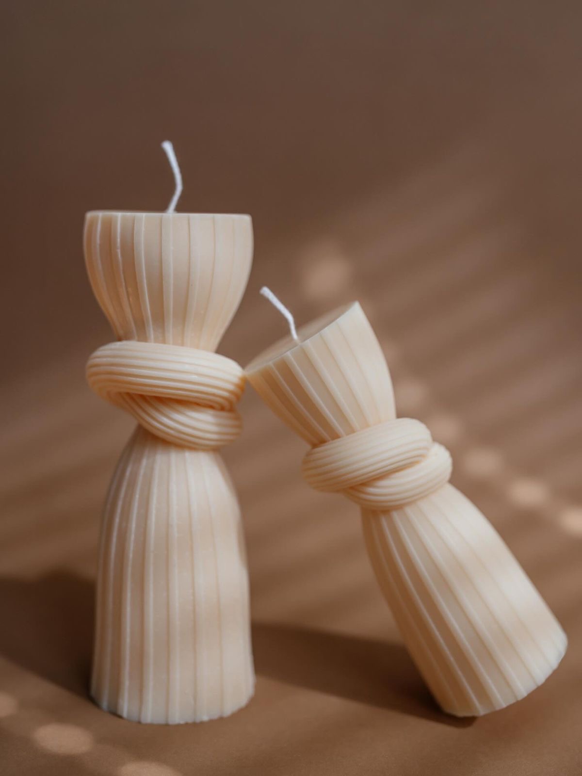 Knotted Column Candle — A ribbed column cinched with a sculptural knot.